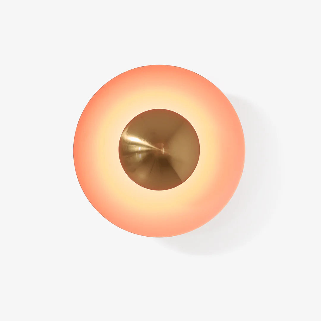 Round light fixture with gradient color from orange to gold on a white background