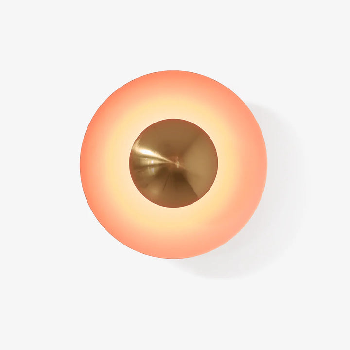 Round light fixture with gradient color from orange to gold on a white background