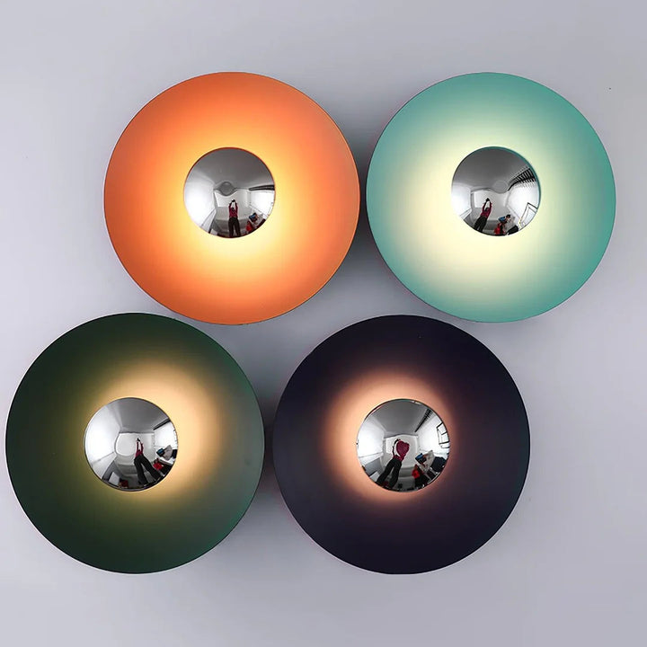 Four round wall lights in orange, green, black